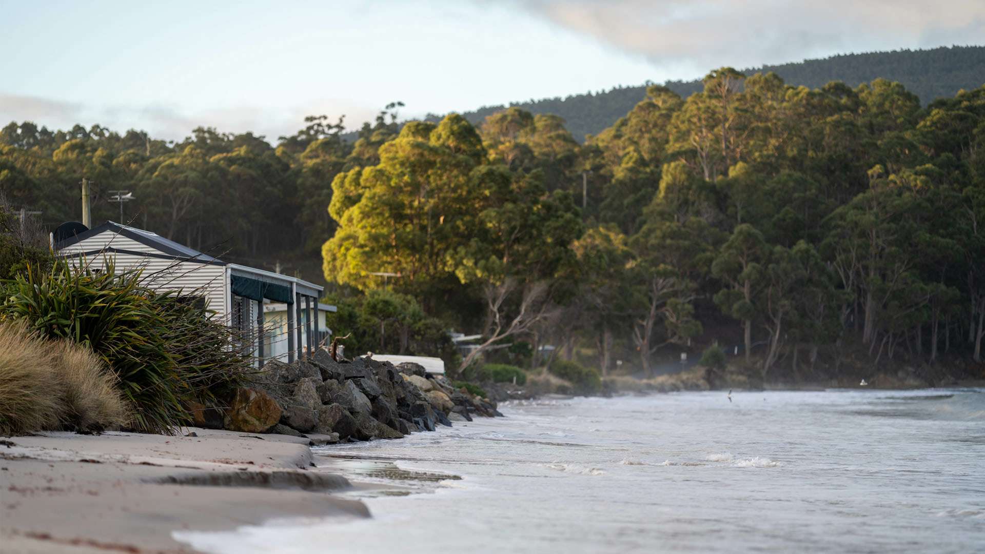 House on the coast with increasing water level